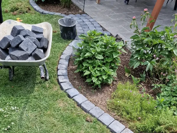 Gartenarbeiten mit bepflanzten Beeten, Pflastersteinen und gepflegtem Rasen in Sinzing.